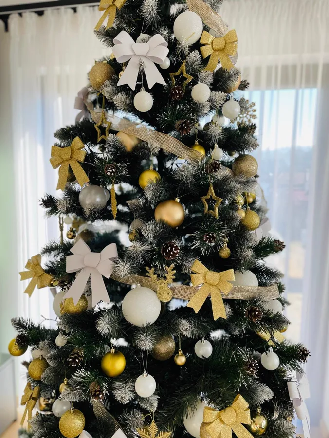 Christmas tree with golden ornaments and elegant bows